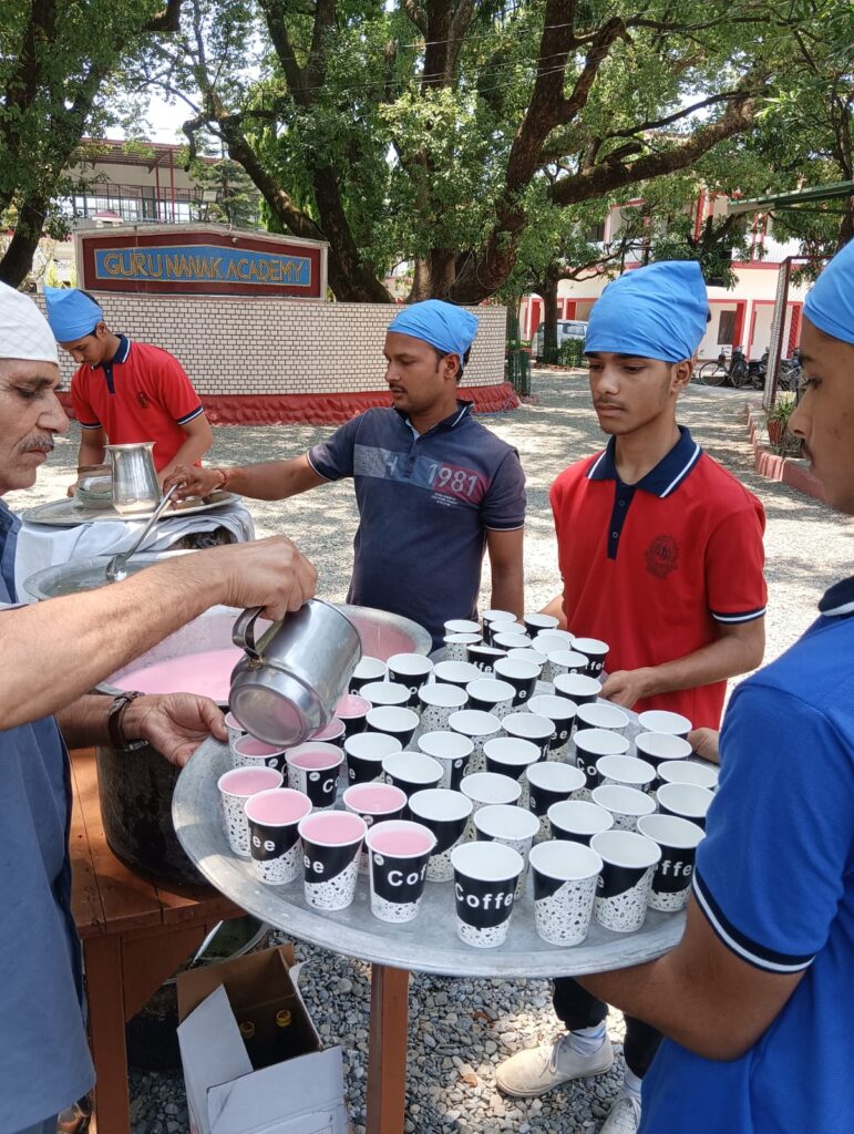 Guru Arjun Dev ji Shahidi purab children and staff helping out in distribution of prasad